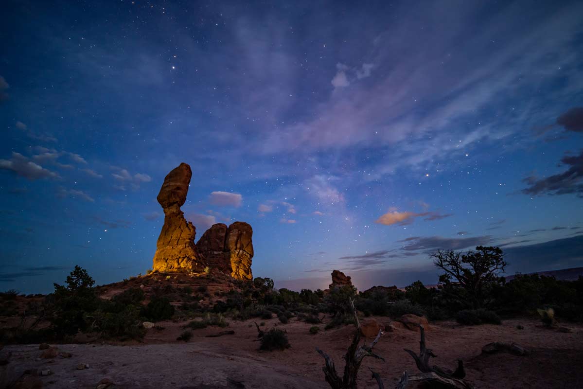 Car lighting the Balanced Rock at Arches National Park